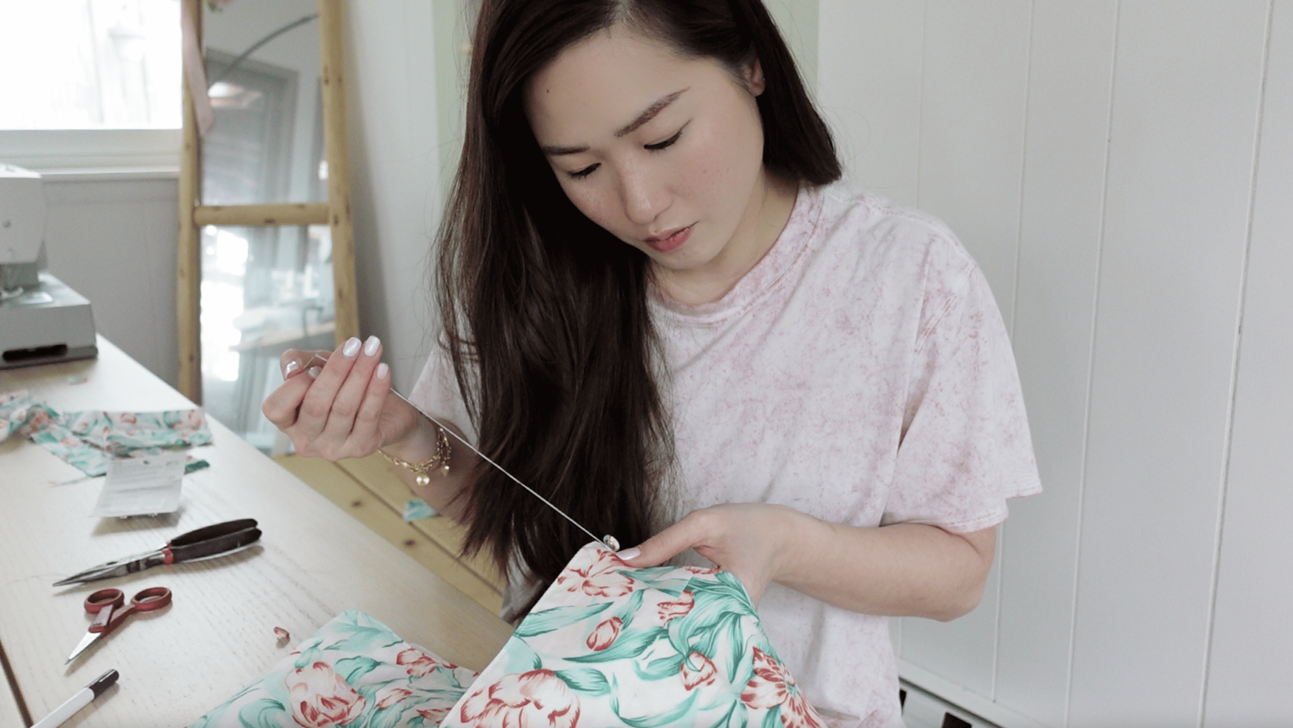 Tiffany Toh sewing a button